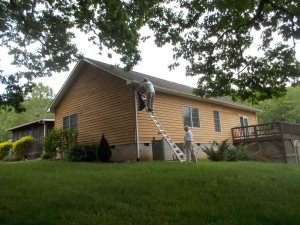 052615 Bob cleaning our gutters and eaves