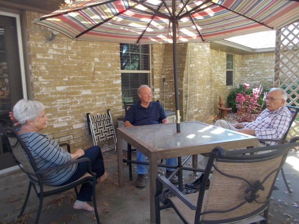 Martha, Perry, and John chatting on the patio