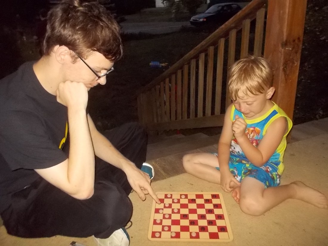 062416 D and Logan play checkers.JPG