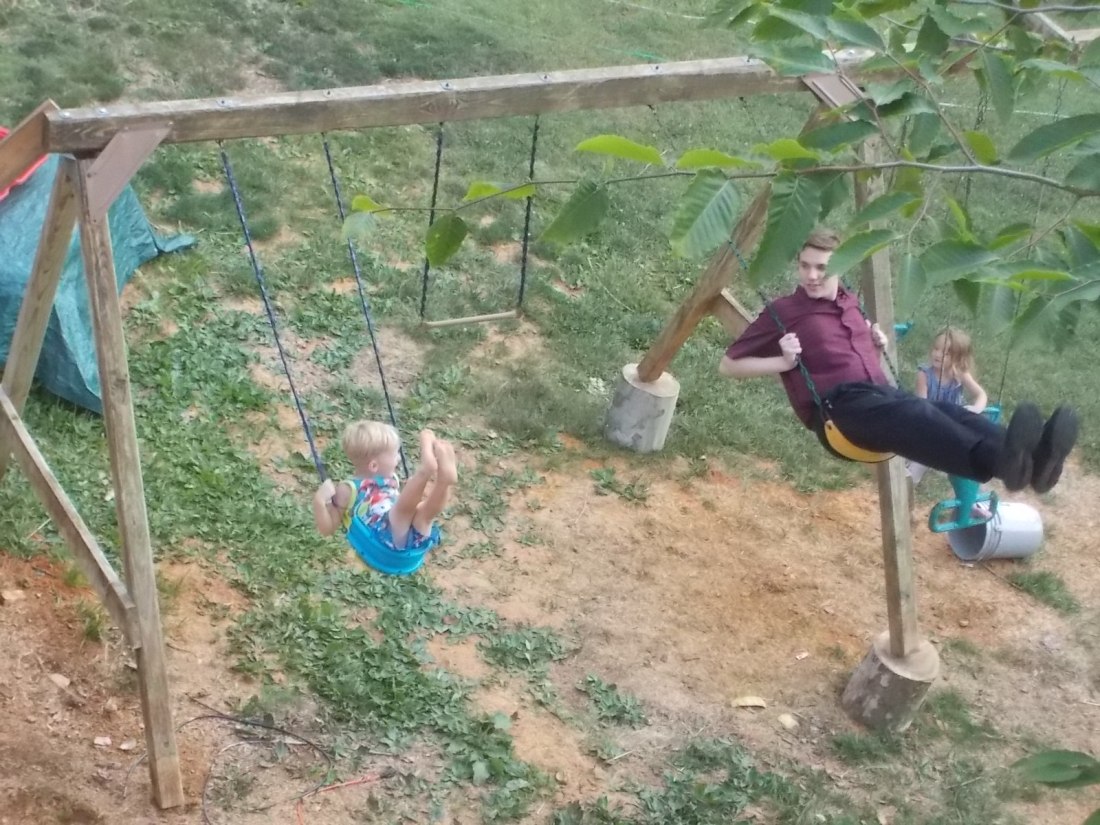 062416 Logan N on new swing set.JPG