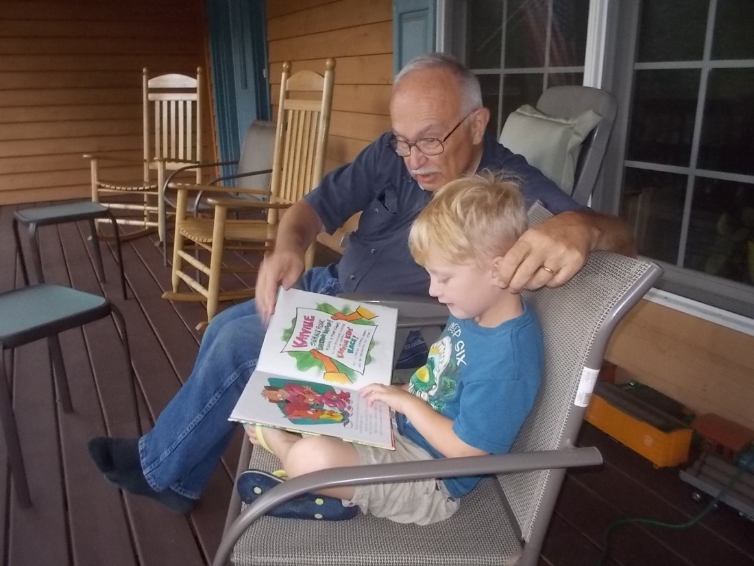 072116 Logan reads to Grandpa John.JPG