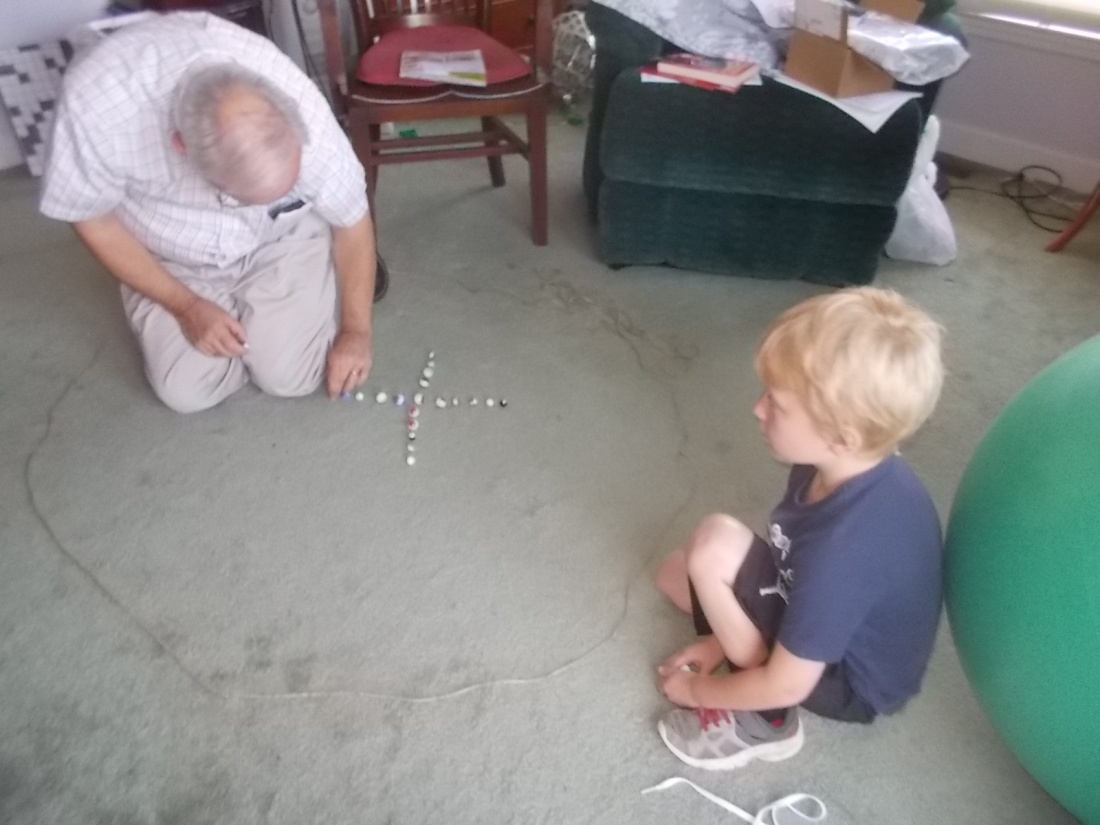 072517 Setting up game of marbles.jpg