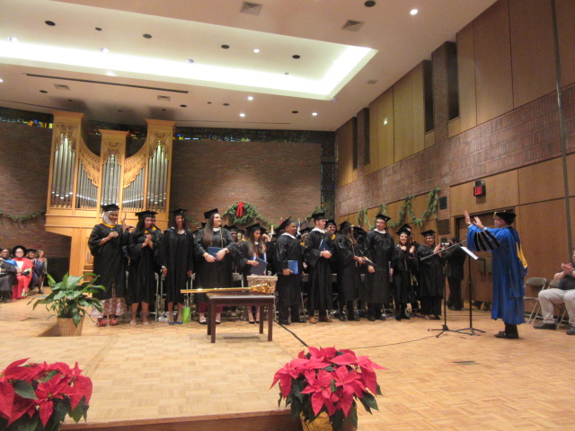 121618 David graduates  (9) Changing tassels.JPG